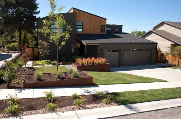 raised modern home with front yard landscaping