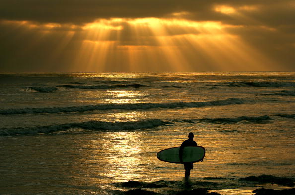 surfer standing on the beach