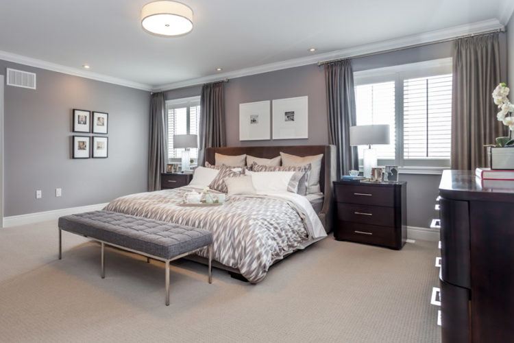 bedroom with gray walls and tan carpet