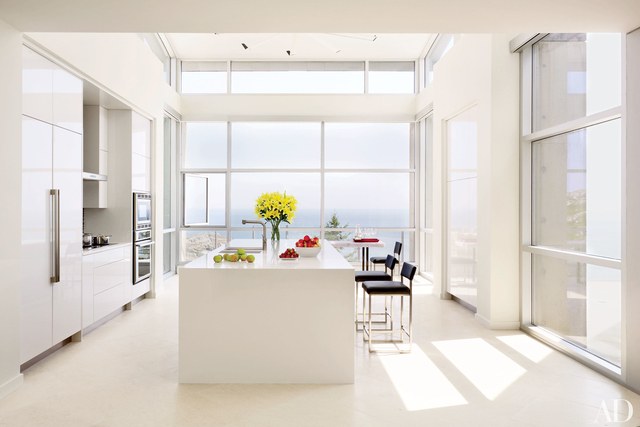 white kitchen with floor to ceiling windows