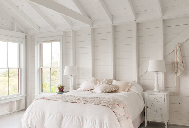 all white bedroom with vaulted ceiling