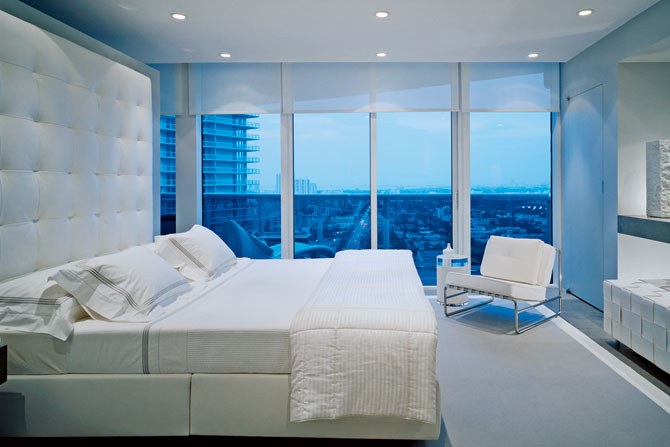 all white bedroom with floor to ceiling windows