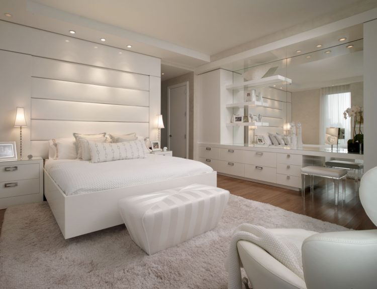 bedroom with white decor and wood flooring