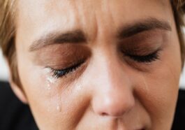 Tears on face of crop anonymous woman