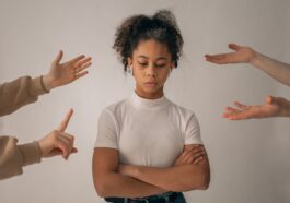 Faceless people scolding discontent black girl