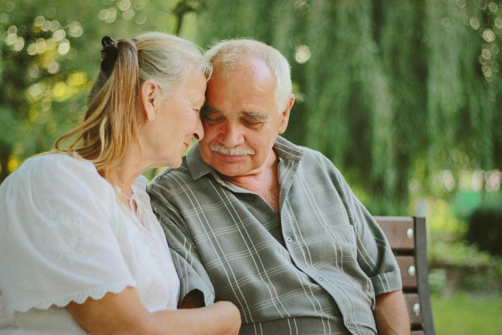 Elderly Couple Sitting on Bench 