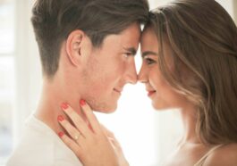 Close-up Photo of Hugging Couple Facing Each Other While Smiling