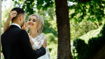 Couple Standing Under Tree