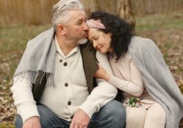 Happy senior couple hugging in autumn park