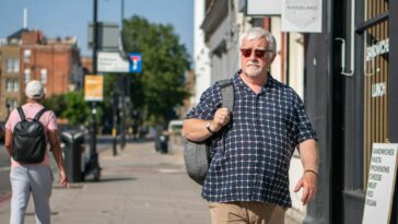a man walking down a sidewalk