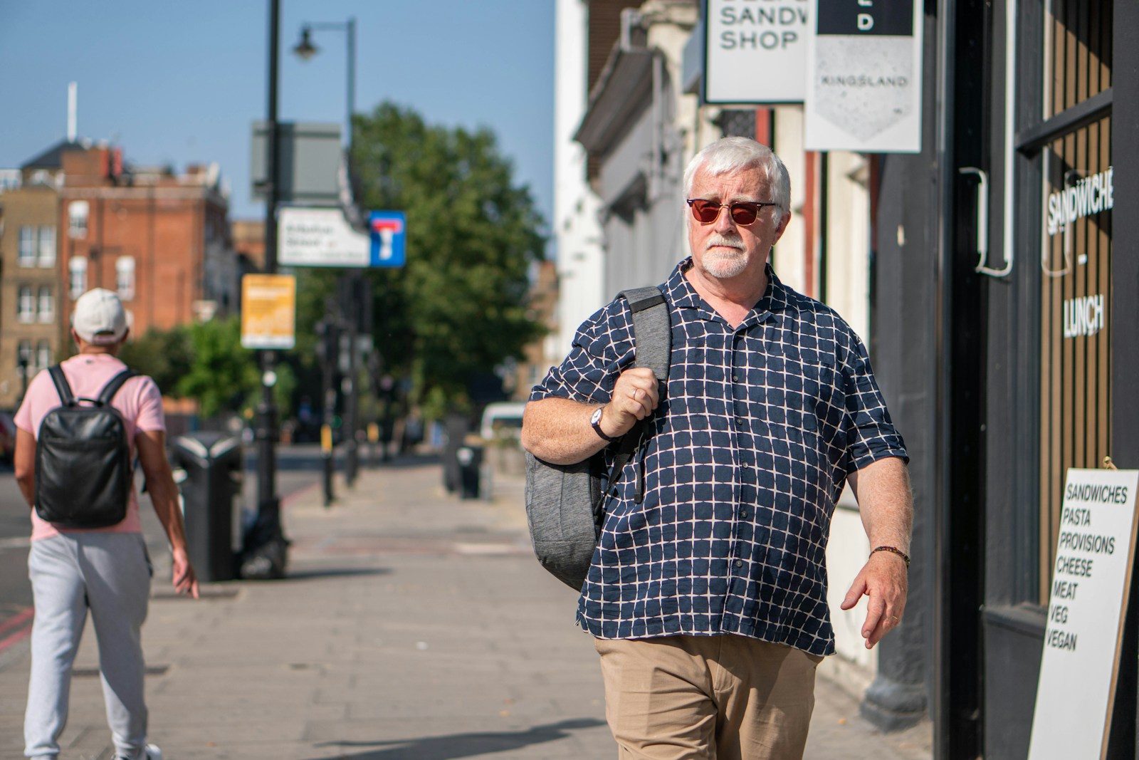 a man walking down a sidewalk
