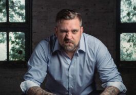 Man Sitting on Black Leather Padded Chair