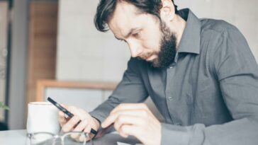 A Man Staring at His Smartphone