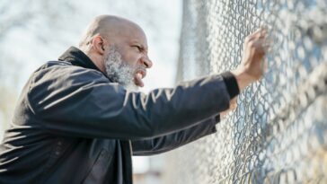 Angry Man Grasping Fence Net