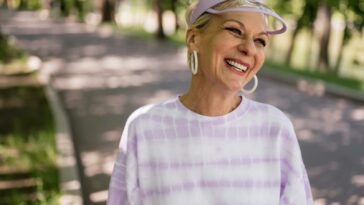 An Elderly Woman with Lavender Hat Smiling