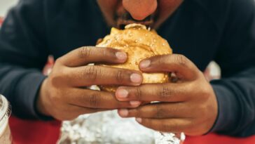 man eating hamburger
