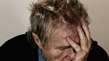 Man Holding His Face