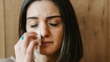 Unhappy female crying wiping away tears