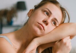 Tired housewife leaning on mop during housework