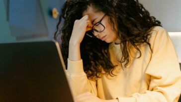 A Tired Woman using a Laptop