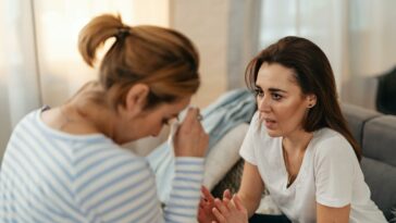 An intimate and emotional discussion between two women in a home environment.