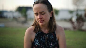 woman in halter top with sunglasses on head
