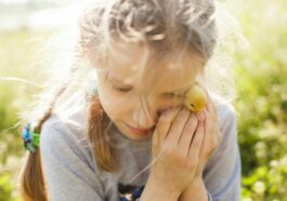 woman in gray long sleeve shirt holding yellow fruit