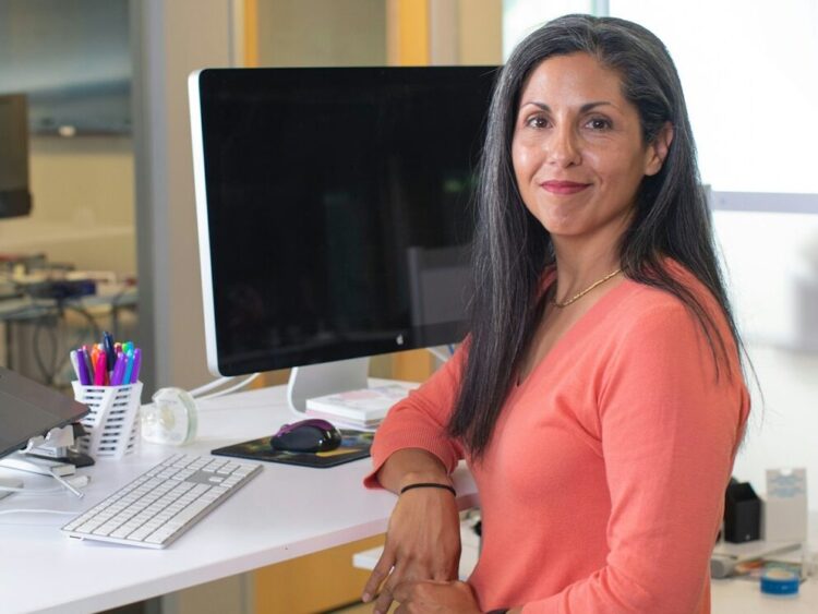 woman in orange long sleeve shirt sitting on chair