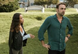 An interracial couple having an intense conversation outdoors, highlighting relationship conflict.