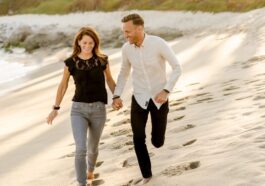man in white dress shirt and woman in black dress walking on beach during daytime