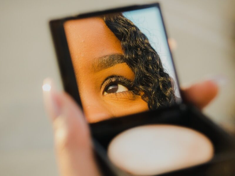 a woman holding a compact compact compact compact compact compact compact compact compact compact compact compact