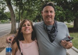 man in gray crew neck shirt standing beside woman in pink tank top