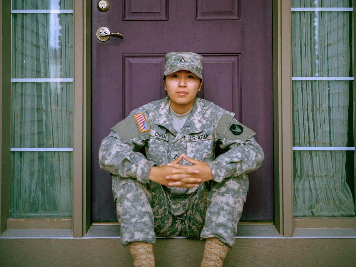 woman sitting in front of closed door