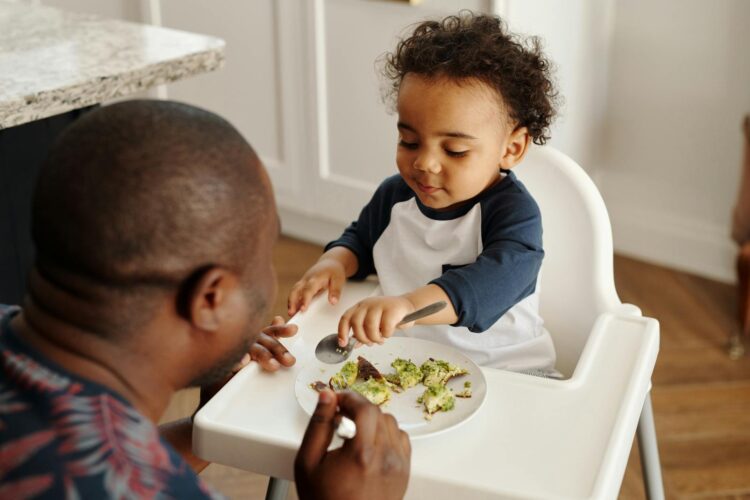 A father and son share a bonding moment during breakfast at home.