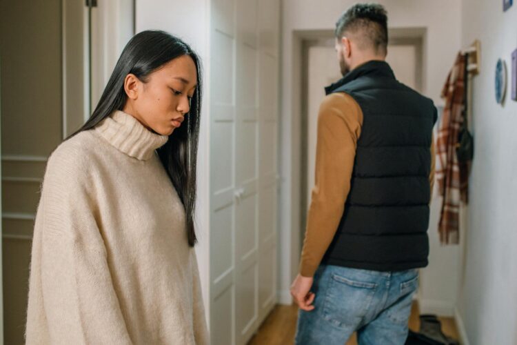 A couple experiencing relationship issues in a hallway, conveying emotional tension.