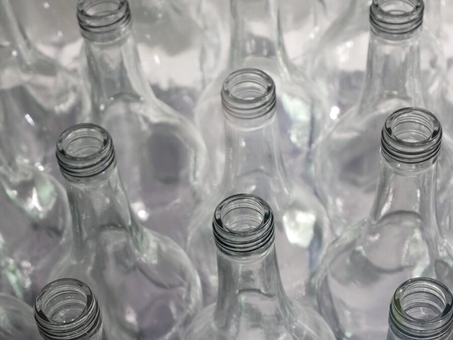 clear glass bottles on brown wooden table