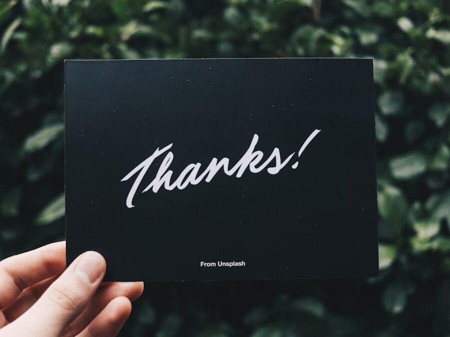 person holding Thanks card