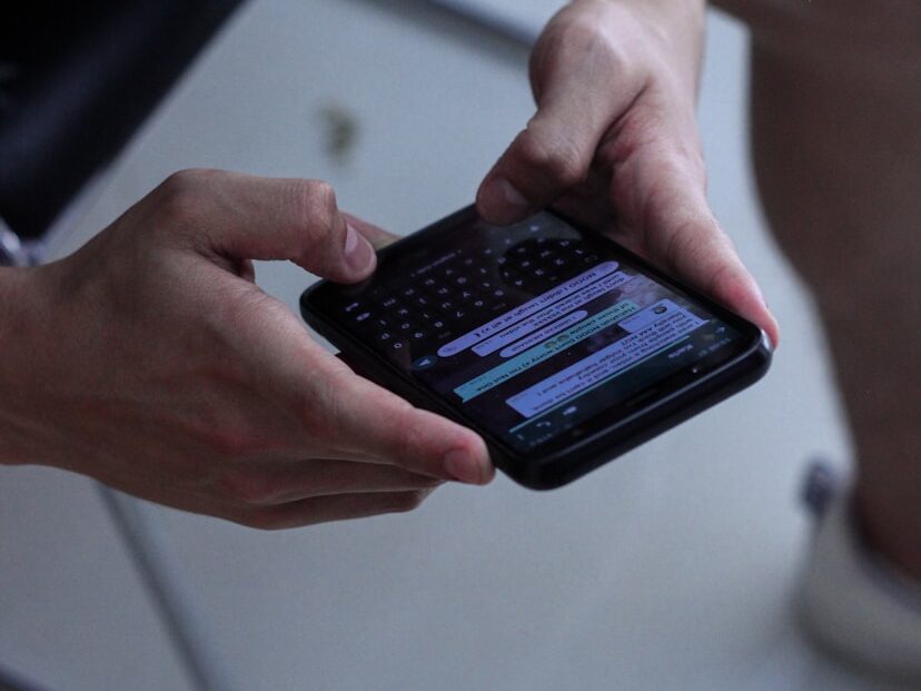 person holding black iphone 4