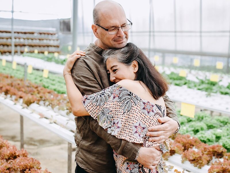 man hugging woman inside garden house
