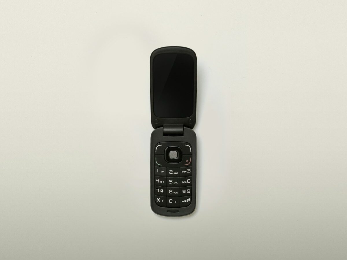 turned-off black flip-phone