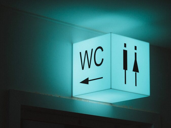 white and blue wall mounted exit sign