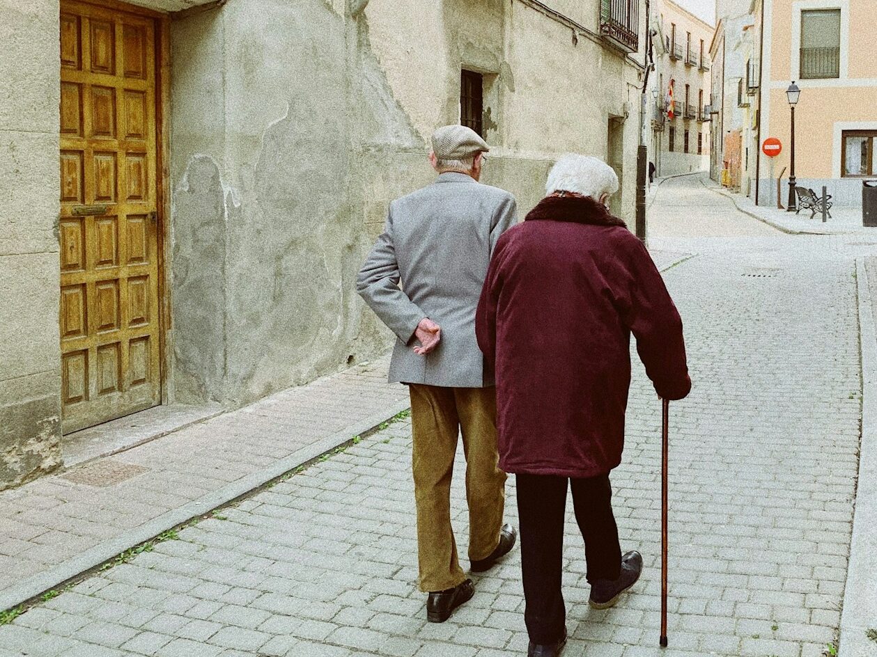 man and woman walking near closed wooden door