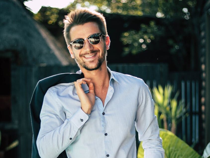 Confident young man in a stylish suit outdoors, exuding charm and elegance.