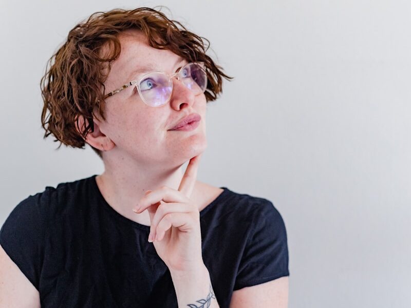 a woman wearing glasses and a black shirt