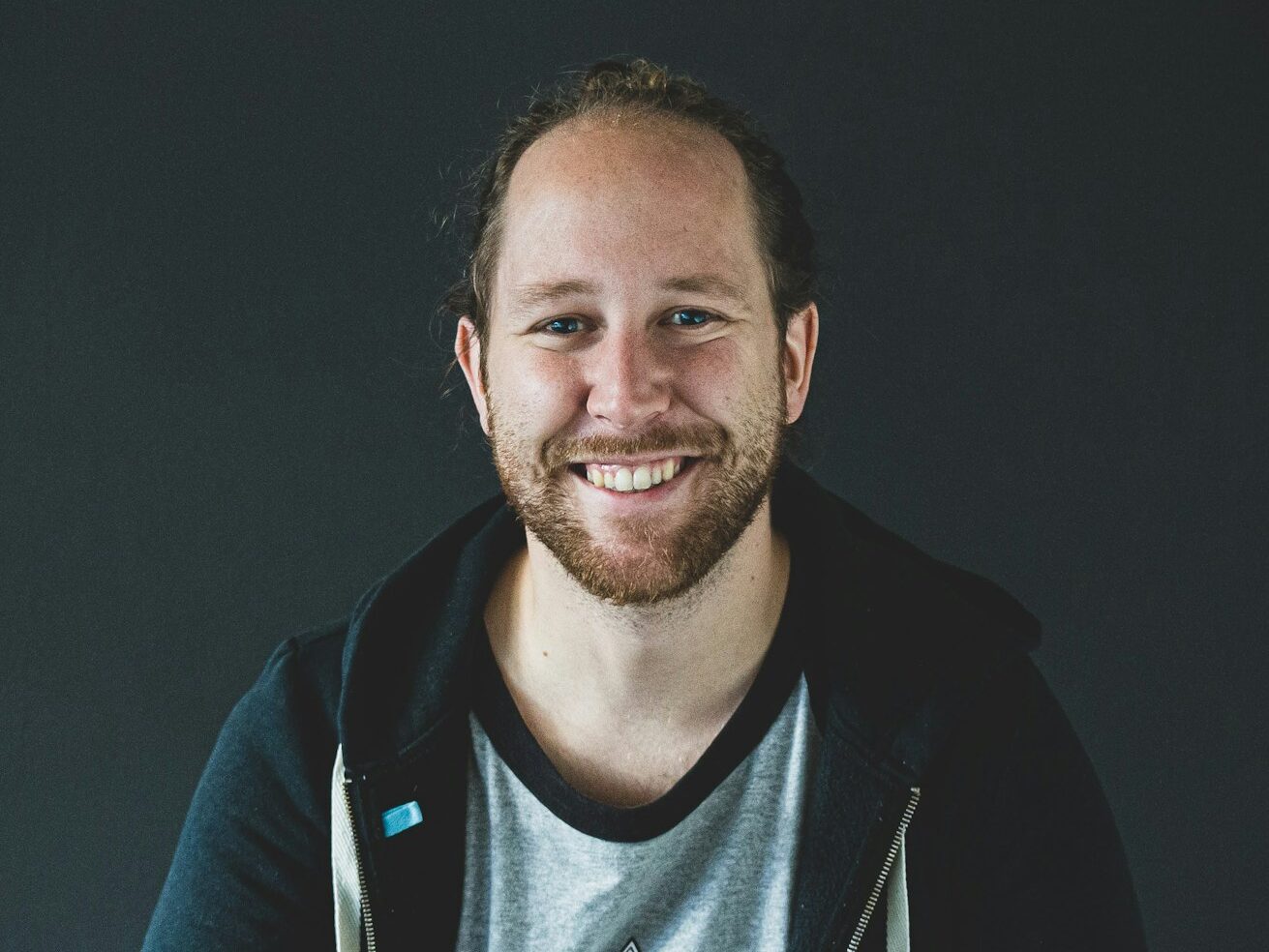 man in black jacket smiling