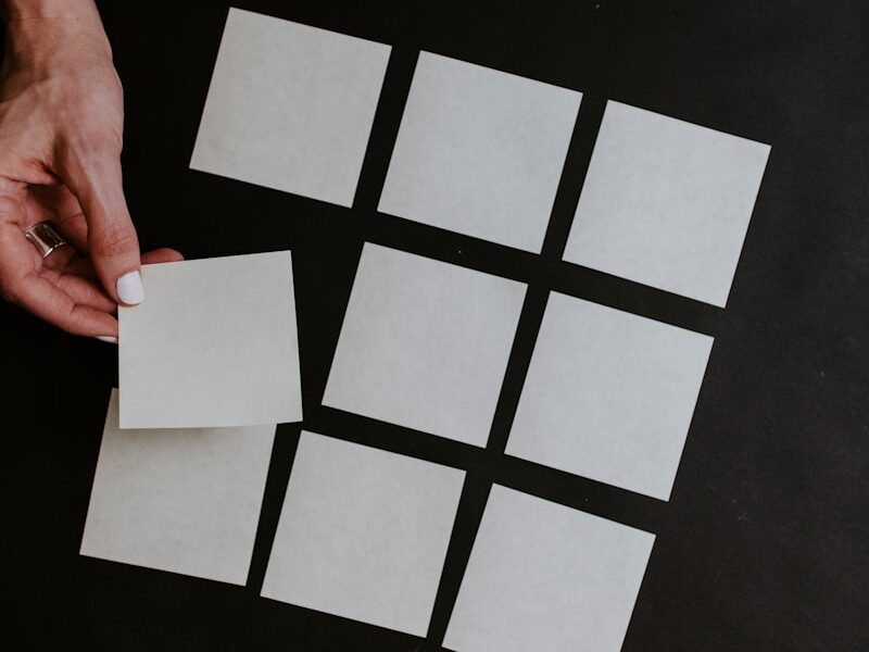 person holding white and black checkered card