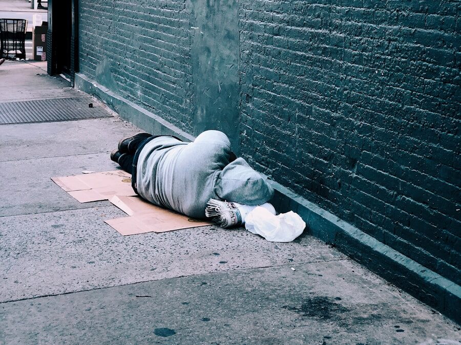 man lying on brown cardboard box