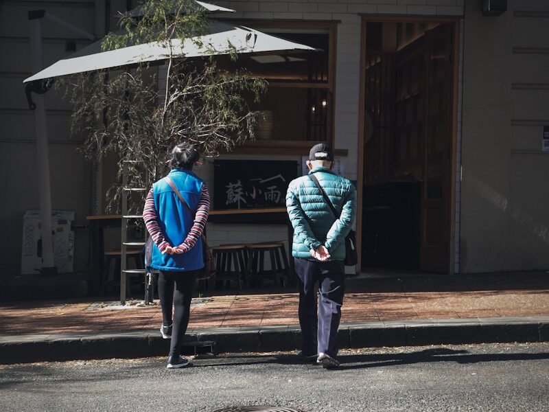 a couple of people standing on the side of a road