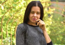 A woman in black and white shirt standing on a path