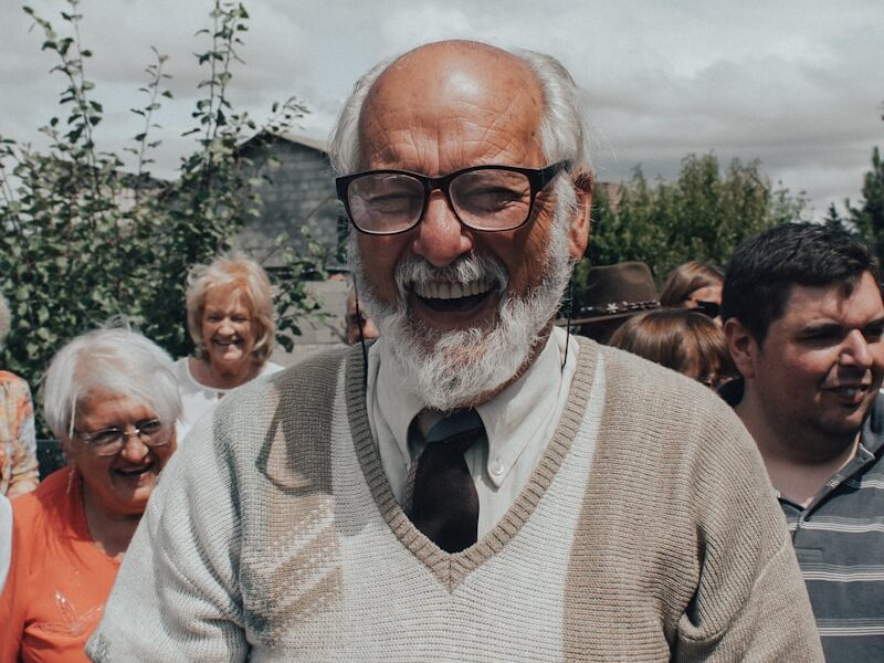 man in gray sweater wearing black framed eyeglasses
